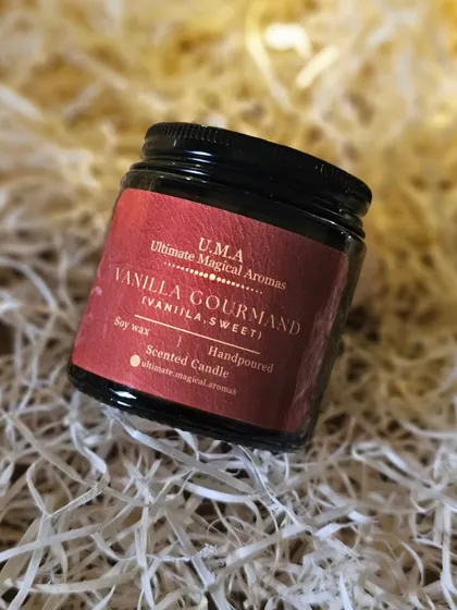 My 'Vanilla Gourmand' candle nestled in soft packing material, ready to be gifted or enjoyed. Its delightful aroma elevates any space.