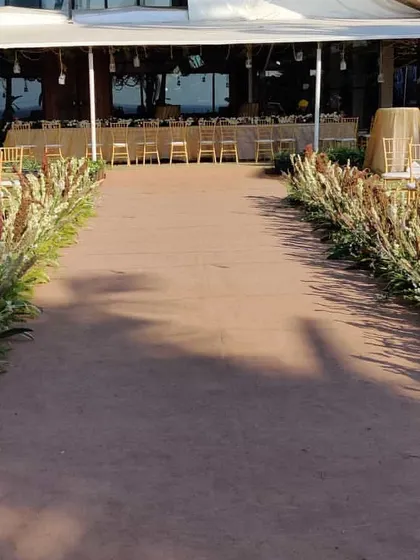 A simple and natural aisle for a rustic beach wedding. We lined the path with wild pampas grass and other dried florals, creating an earthy and beautiful walkway to the mandap.