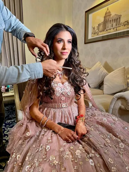 Another behind-the-scenes moment, capturing the full effect of the princess gown and the glamorous makeup.
