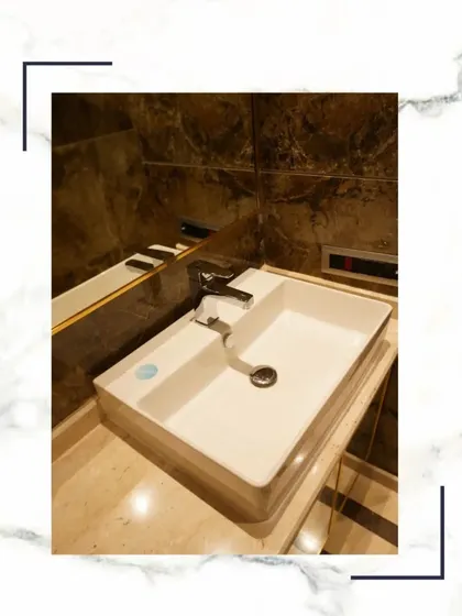 A close-up of a modern vessel sink and chrome faucet, set against a backdrop of rich, dark marble. It’s a small detail that speaks volumes about the quality of our homes.