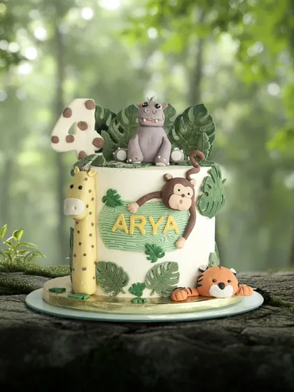 A wild adventure for Arya's fourth birthday. This jungle-themed cake is set against a lush forest backdrop, highlighting the hippo, giraffe, monkey, and tiger.