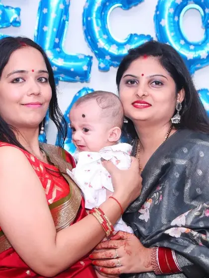 Guests hold a newborn baby at a 'Welcome Baby' party. We capture the joy and excitement as friends and family meet the new arrival.