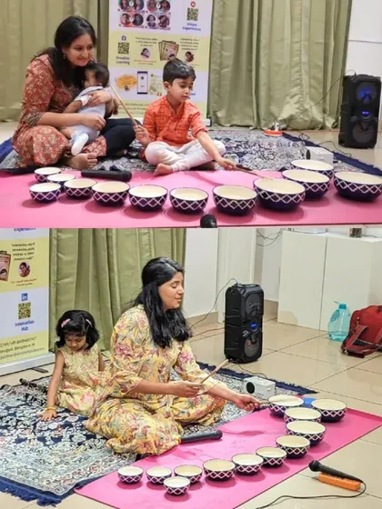 A mother helps her little one hold the sticks for the Jaltarang, while another mom and child duo explore together. Our camps are filled with these small, precious moments of shared discovery.