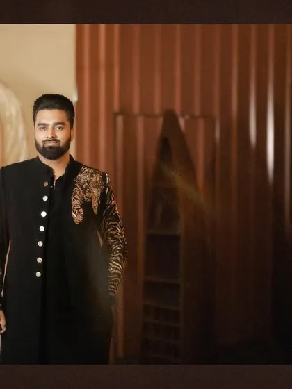 A classic, well-lit portrait of the groom in his engagement attire, looking sharp and ready for the celebration.