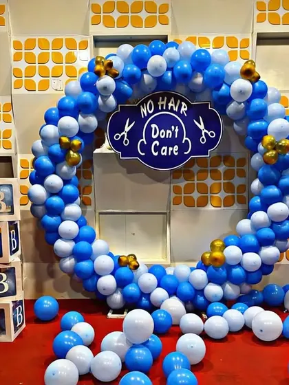 For a child's mundan or head shaving ceremony, I offer these fun "No Hair Don't Care" themed backdrops. This setup includes a full ring of blue and white balloons, custom signage, and matching "BABY" blocks, creating a perfect photo spot for your family celebration.