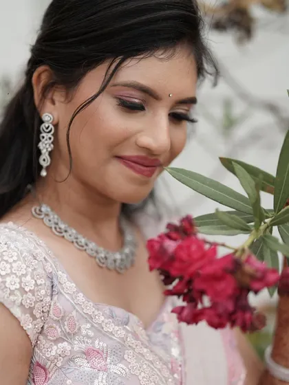 A close-up of Nisarga's reception makeup. The focus is on flawless skin, a soft pink eyeshadow, and a matching lip color for a harmonious and elegant look.