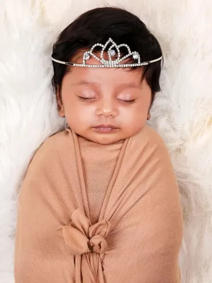 A simple swaddle paired with a delicate tiara. This portrait shows how a single, elegant prop can add a touch of magic to a classic shot.