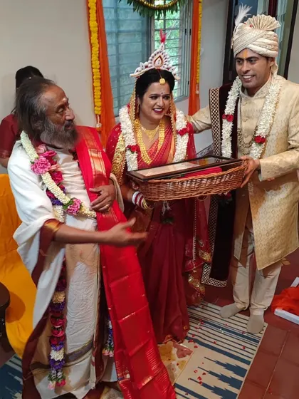 A Bengali bride and groom receive blessings from Gurudev. We celebrate and accommodate diverse cultural traditions, ensuring every wedding is both personal and spiritually uplifting.