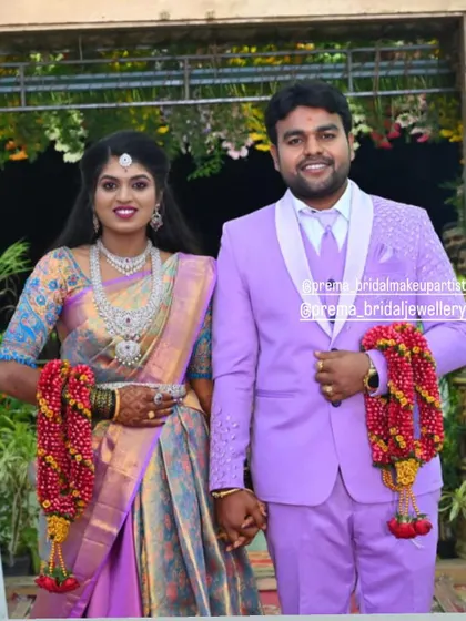 Bride Kaviya and her groom at their reception. She is wearing a beautiful AD stone set that matches her lavender outfit perfectly.