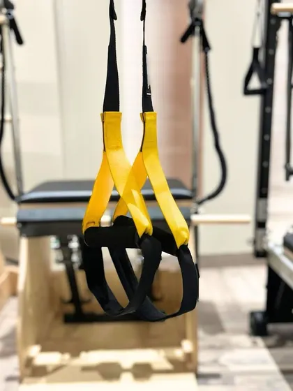 TRX suspension straps hanging in our studio. We incorporate these tools to add a different type of stability and strength challenge to our classes.