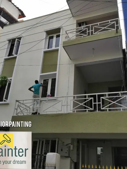 Another view of the exterior painting project, showing the combination of off-white and olive green for a classic look.