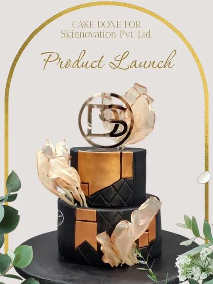 This elegant two-tiered cake was the highlight of a corporate product launch for Skinnovation Pvt. Ltd. The design incorporates the company's logo and brand colours with sophisticated elements like edible gold leaf and a geometric pattern.