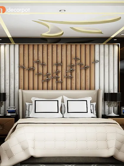 A luxurious bedroom design featuring a floor-to-ceiling headboard with vertical fluting in wood and white upholstery. The metallic fish wall art adds a unique, artistic touch.