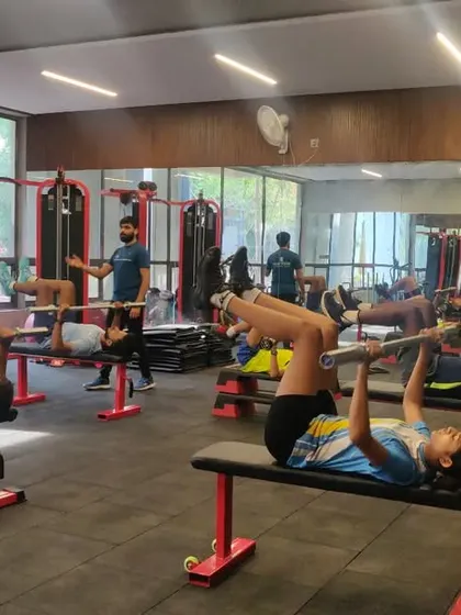 A busy gym session with our young athletes working on foundational strength exercises like the bench press under careful supervision.