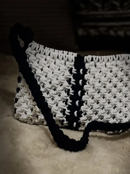 This photo really shows the beautiful texture of the macrame knots on the black and white baguette bag.