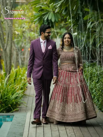 Walking together by the poolside. This full-length portrait captures the couple's elegance and the beautiful decor of their engagement venue.