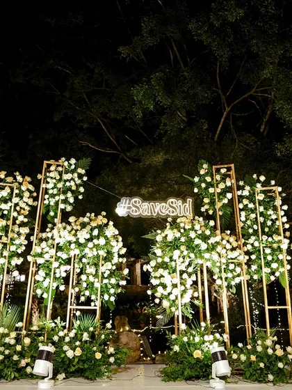 A fun photo booth setup with a custom neon sign for the couple.