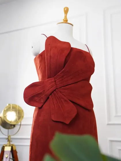A close-up of the 3D statement flower on the red evening dress, highlighting the texture and craftsmanship of this standout detail.