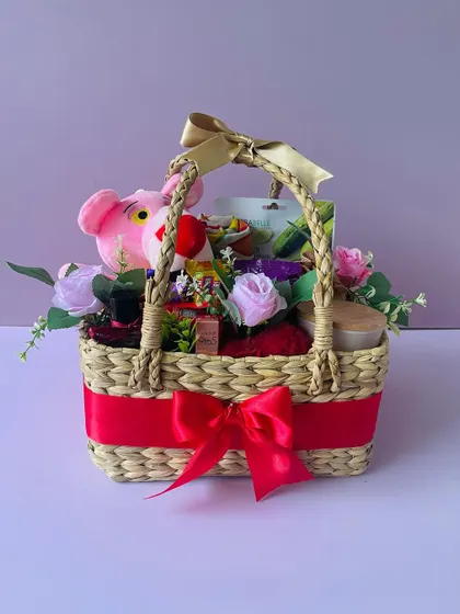 This fun birthday hamper, packed in a Kauna basket, includes a Pink Panther soft toy and lots of treats, customized for the recipient.