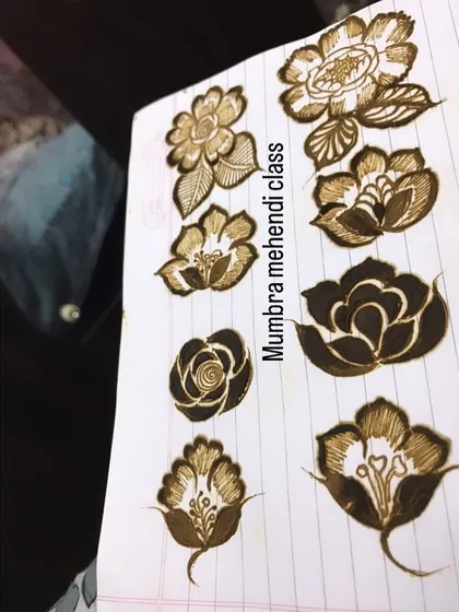 A collection of different flower designs on a practice sheet. Each one requires a slightly different technique to master.