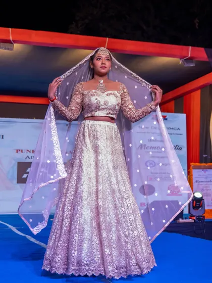 A full-length view of the beautiful white and gold bridal lehenga designed by our student.