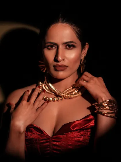 Light and shadow are my tools to sculpt a mood. Here, I used hard lighting to create a dramatic, high-contrast portrait that highlights both the texture of the velvet outfit and the model's powerful presence. This is perfect for a glamorous, editorial look.