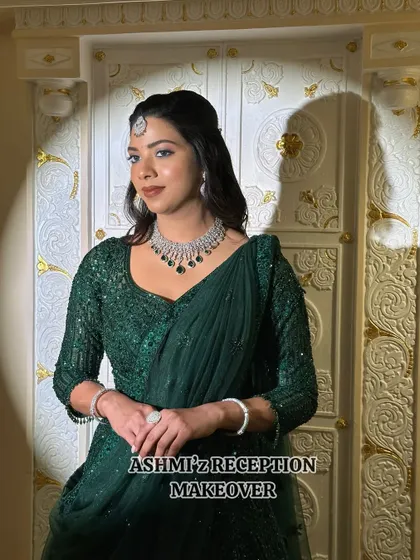 An elegant reception makeover for a bride in a gorgeous emerald green lehenga. The makeup is kept soft and sophisticated, with a focus on glowing skin and defined eyes to match the outfit's grace.