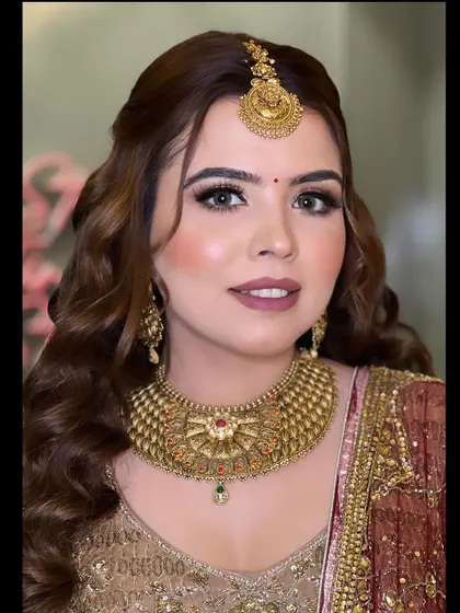 A beautiful smiling portrait, showcasing the complete look with the traditional maang tikka and jewellery.