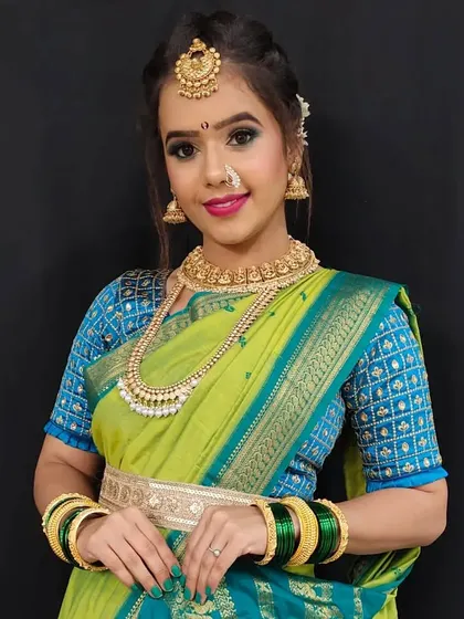 A full-frontal portrait of the Maharashtrian bridal look, showcasing the symmetry of the makeup and the traditional 'nath' (nose ring).