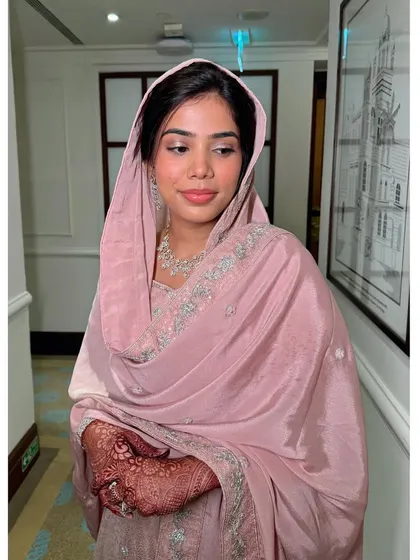 This shot shows the beautiful harmony between her makeup, jewelry, and the soft pink of her outfit.