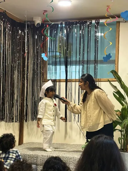 A young performer takes the stage with a microphone during our Children's Day celebration. We encourage every child to express themselves and build confidence in front of a supportive audience.