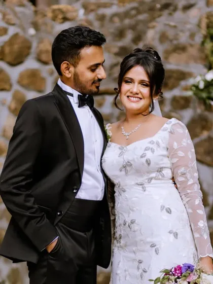 A classic portrait of the happy couple. Her elegant updo and soft makeup look absolutely timeless next to his sharp tuxedo.