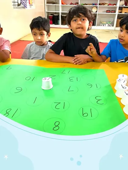 Four boys are gathered around a table, focused on a number matching game. This image captures a moment of teamwork and concentration during one of our fun learning activities.