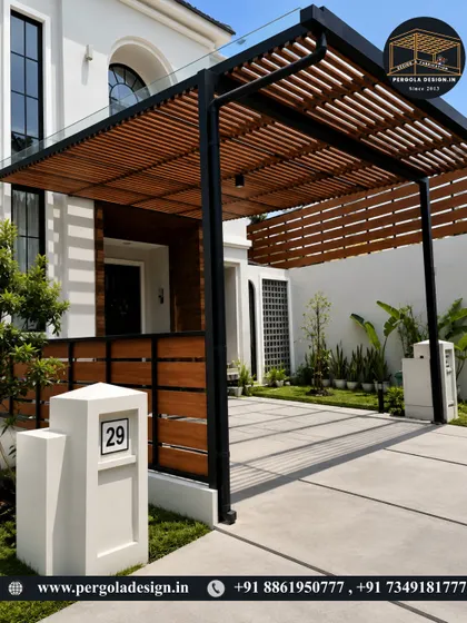 This elegant structure serves as a carport and a covered walkway to the entrance. The design features a glass top for rain protection and wooden slats for shade, blending security with sophisticated design.