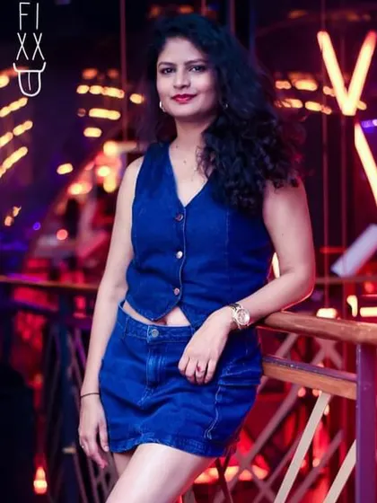 A guest looking chic against the neon lights of The Fixx Bar.