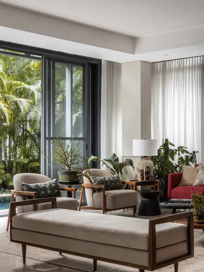 This wide view shows the complete living arrangement, with a daybed and armchairs creating multiple conversation zones. The space is designed to be flexible for both intimate family time and larger gatherings.