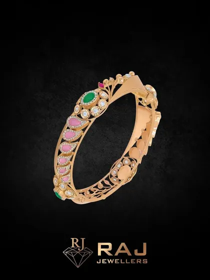 This bangle reflects your inner light with its vibrant design. The piece features a mix of pink and green stones set in an intricate pattern, reflecting the beauty of traditional Indian jewellery.