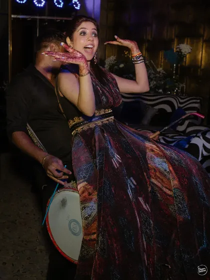 Pure joy on the dance floor as the bride dances with the dhol player. Capturing this kind of high-energy, candid fun is what it's all about.