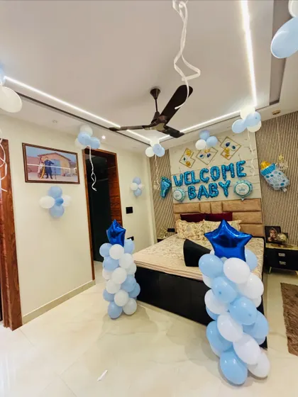 A wide-angle view of the blue and white 'Welcome Baby' room decoration.