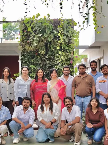 A group photo of our architectural team in front of our office's green wall. This image captures the vibrant, youthful energy that drives our innovative design work.