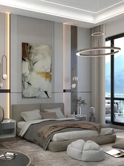 A modern bedroom with large windows offering a beautiful view. I designed this space with a comfortable armchair and soft furnishings to create a perfect reading nook by the light.