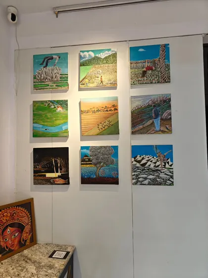 A grid of nine surreal landscape paintings by artist Baiju, part of the "Vernissage Art Exhibition."