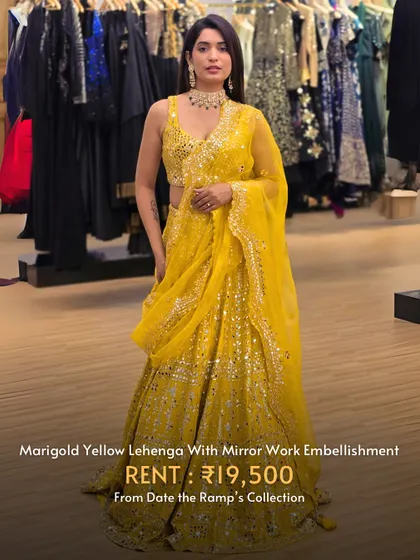 A marigold yellow lehenga with stunning mirror work embellishment. This is a true statement piece.