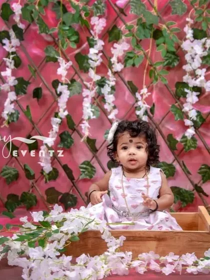 A delicate and beautiful Wisteria theme for a kids' photoshoot. The backdrop of cascading white flowers and green vines creates a magical, enchanted garden atmosphere for your little one.
