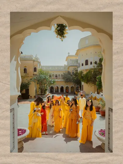 The bride's grand entrance with her family for the Haldi ceremony, framed beautifully by the heritage architecture. A moment of tradition and togetherness.
