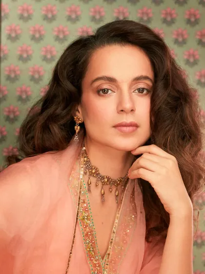 A close-up of Kangana Ranaut in this elegant peach suit. The focus here is on the exquisite Amrapali jewels that elevate the entire look.