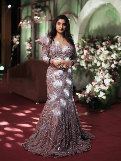 A stunning full-length portrait of the bride in her shimmering mermaid-style reception gown. This shot highlights the intricate details of her fashion-forward choice.
