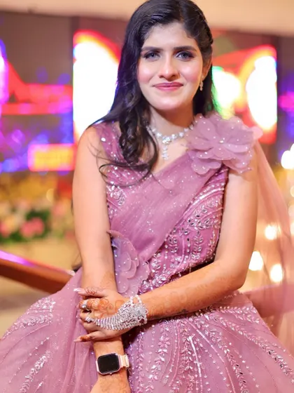A seated portrait, showing the beautiful details of her dress and the soft, glowing makeup.
