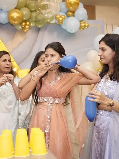 Another view of the balloon and cup relay game at the naming ceremony.