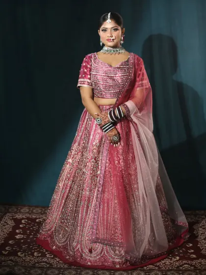 A full-length shot showcasing the beautiful fall of the pink bridal lehenga. It’s a perfect blend of traditional craftsmanship and modern color.